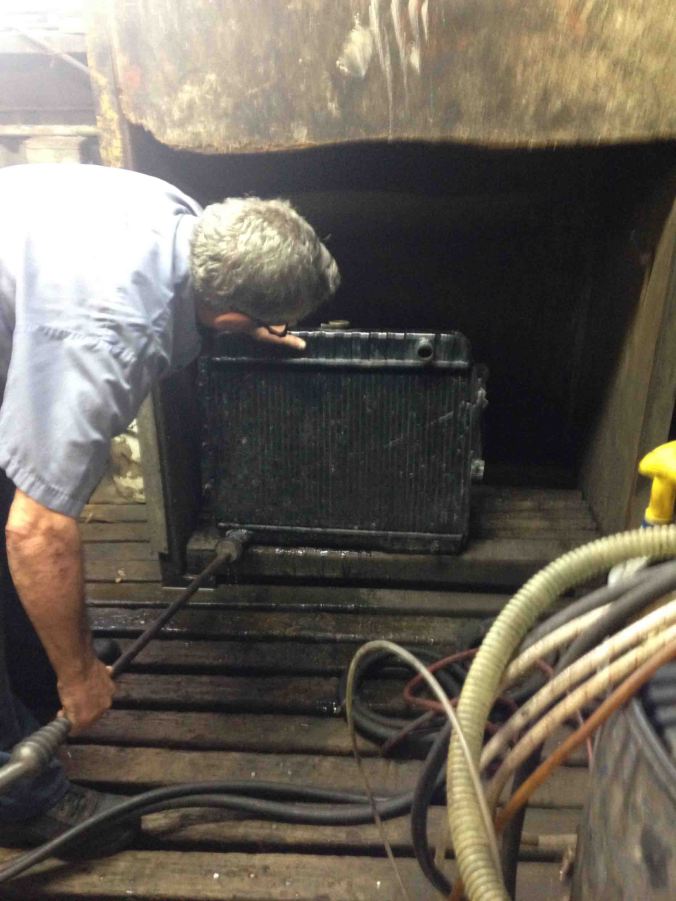 Here's we're filling the rad from the bottom to do a flow test. When the water spews out the top for a second, let go and see how far the water jets from the bottom.  Photo by Challen 