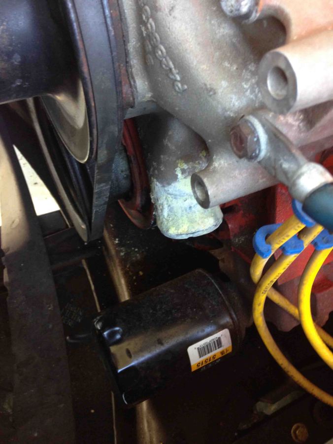 Here's the nasty crud build up on the water pump inlet. before I wire brushed it.